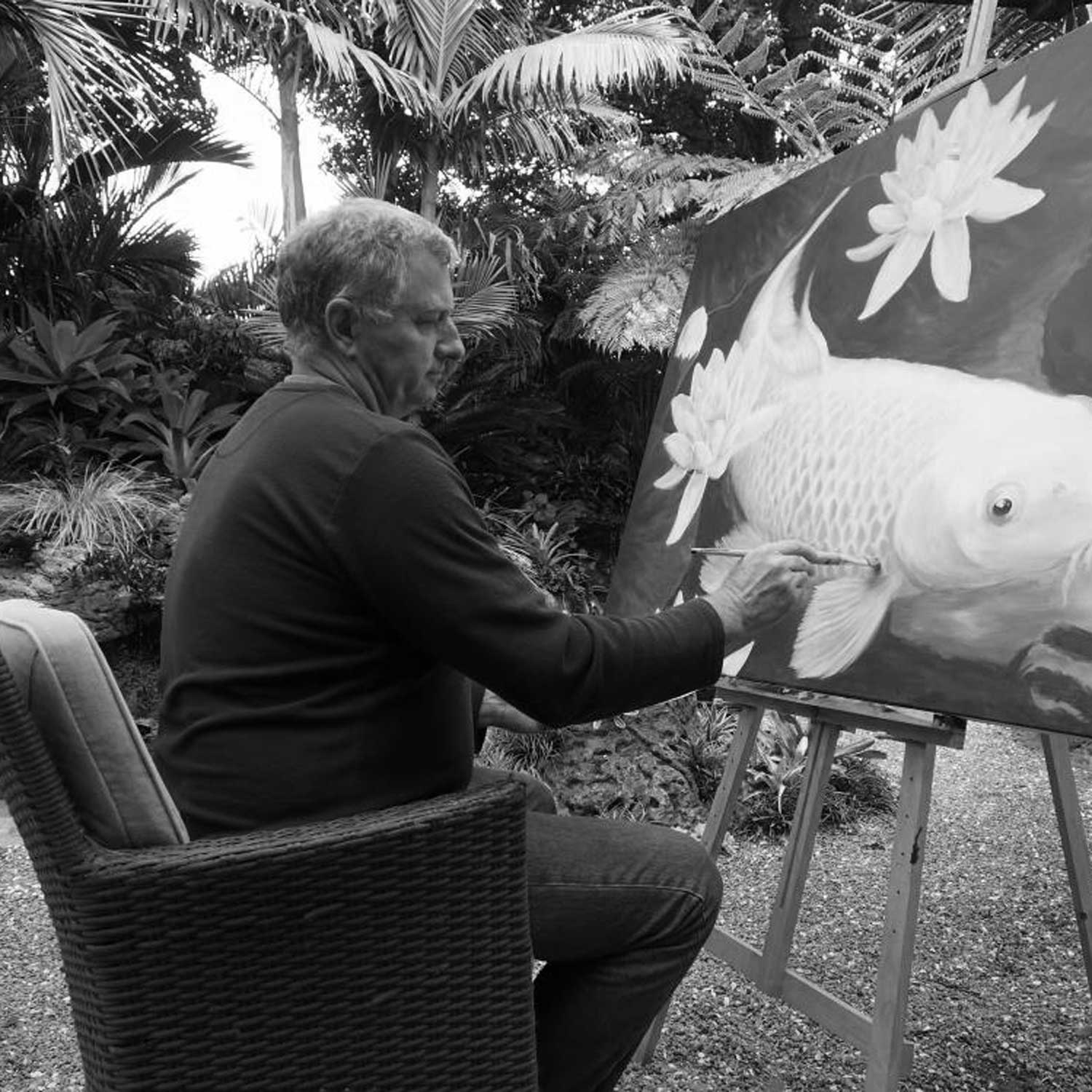 Artist Richard Moore painting in his garden